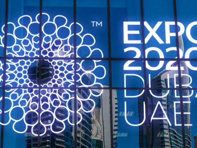 DUBAI, UAE - August 27: skyscrapers in reflection on blue glass. Dubai Expo 2020 Sign.