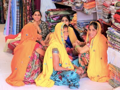 Local women sitting in a store at Johari Bazaar street in Jaipur, Rajasthan, India. Jaipur is the capital and the largest city of Rajasthan.