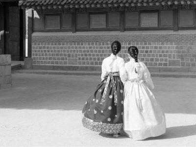Asian Korean woman dressed Hanbok in traditional dress walking in Gyeongbokgung Palace in Seoul, South Korea.